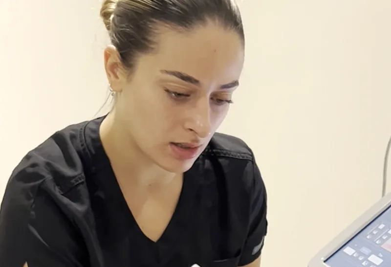 A clinician preparing a patient for a skin treatment at The Hampton Clinic