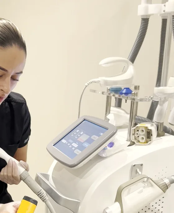 A clinician working across a patient's face during a skin treatment at the clinic